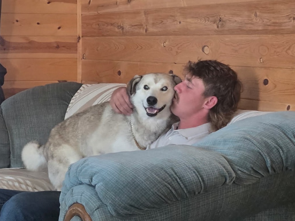 Cody Lambert spends time with Tobias at his home after a volunteer drive to Meadow Lake ended in an unexpected adoption.