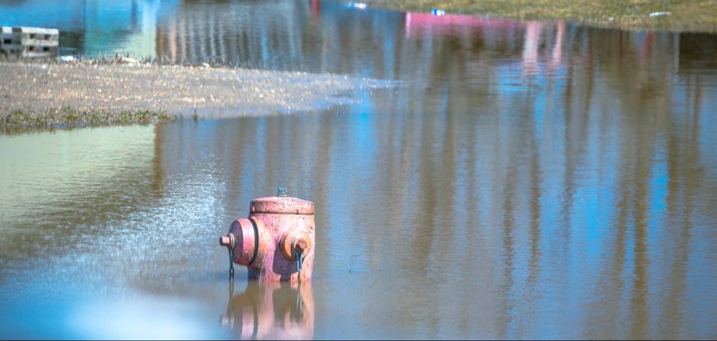 A flooded fire hydrant.