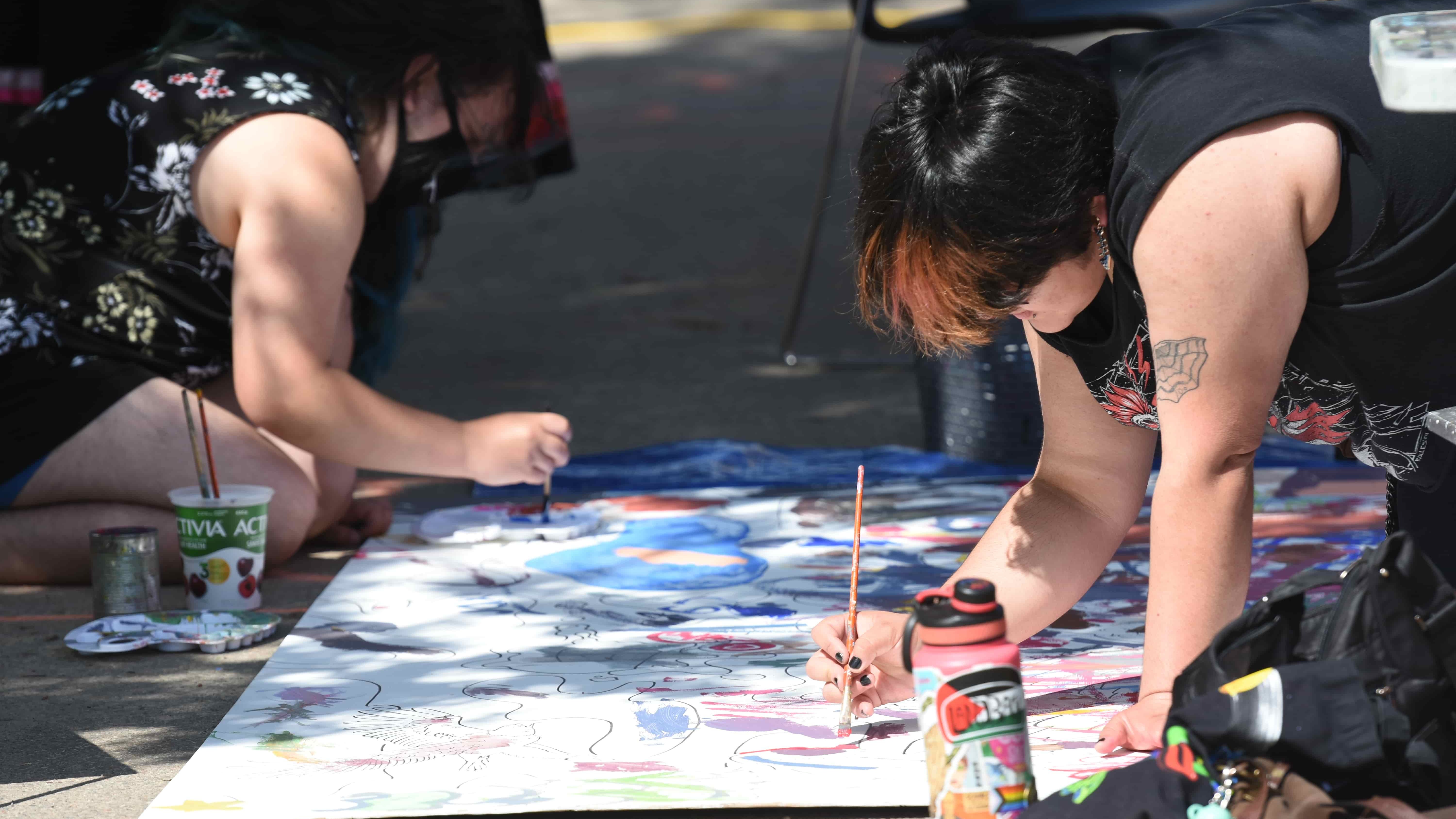 A pair of artists put their skills to work at Art Alley during the annual Street Fair.