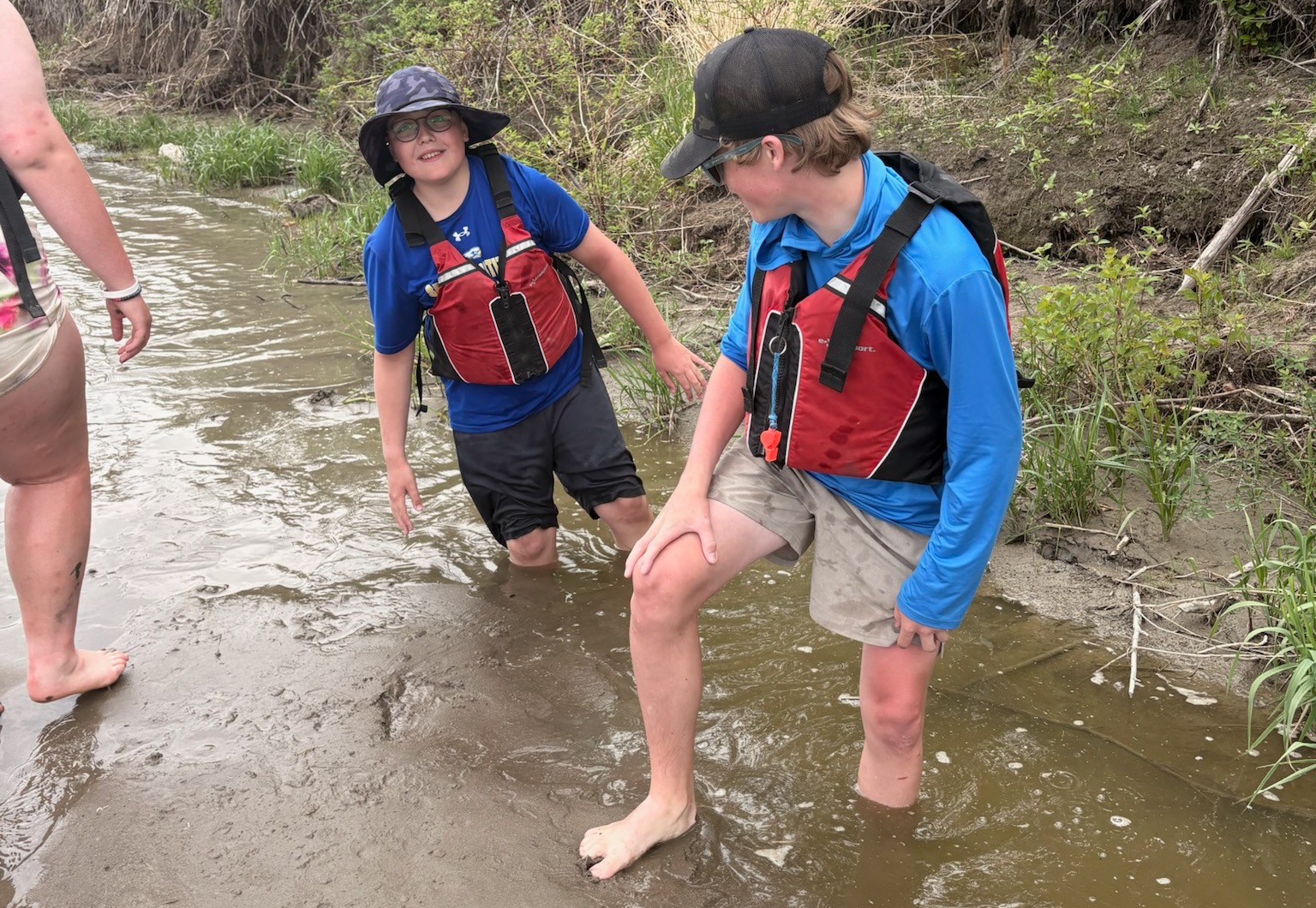Elliot Holden, 13, plays in the mud with fellow students during a stop along the North Saskatchewan River during a 348-kilometre canoe journey marking the 150th anniversary of Treaty 6.