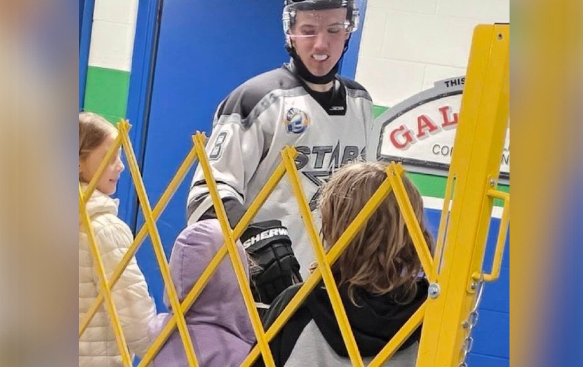 Finlay Klippenstein high-fives Isabella Nelson and Benjamin Nelson, along with their friend Mika, following a Battlefords North Stars game in Kindersley.