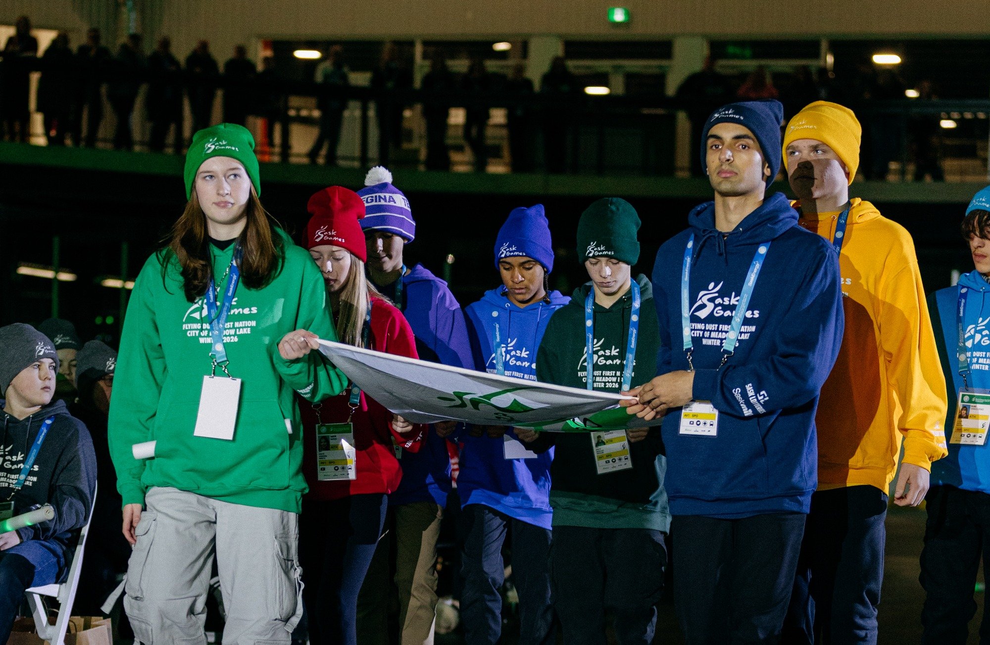 Rivers West athlete Tristan Maatman (right, front, in navy blue) is among the district representatives carrying the Games flag into the arena during the opening ceremony of the 2026 Saskatchewan Winter Games at the Meadow Lake Co-op Centre on Sunday, Feb. 15, 2026.