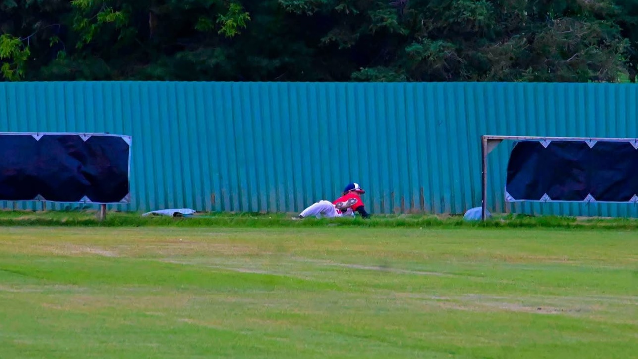 Kaden Cey after crashing through the fence while making a catch in the outfield to keep the Beavers off the scoresheet.