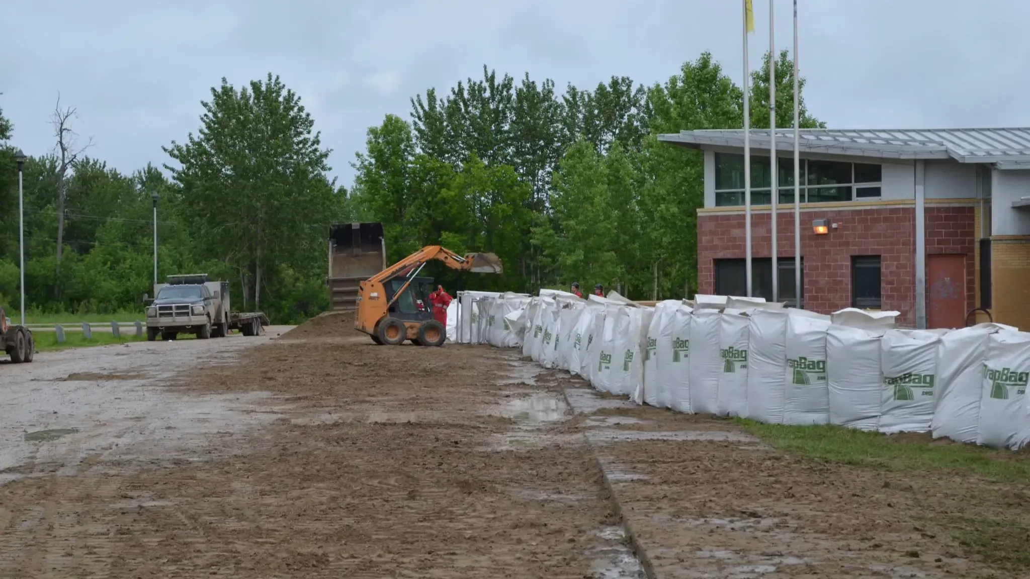 Crews race to erect barriers around buildings in Cumberland House in anticipation of a flood back in 2013.