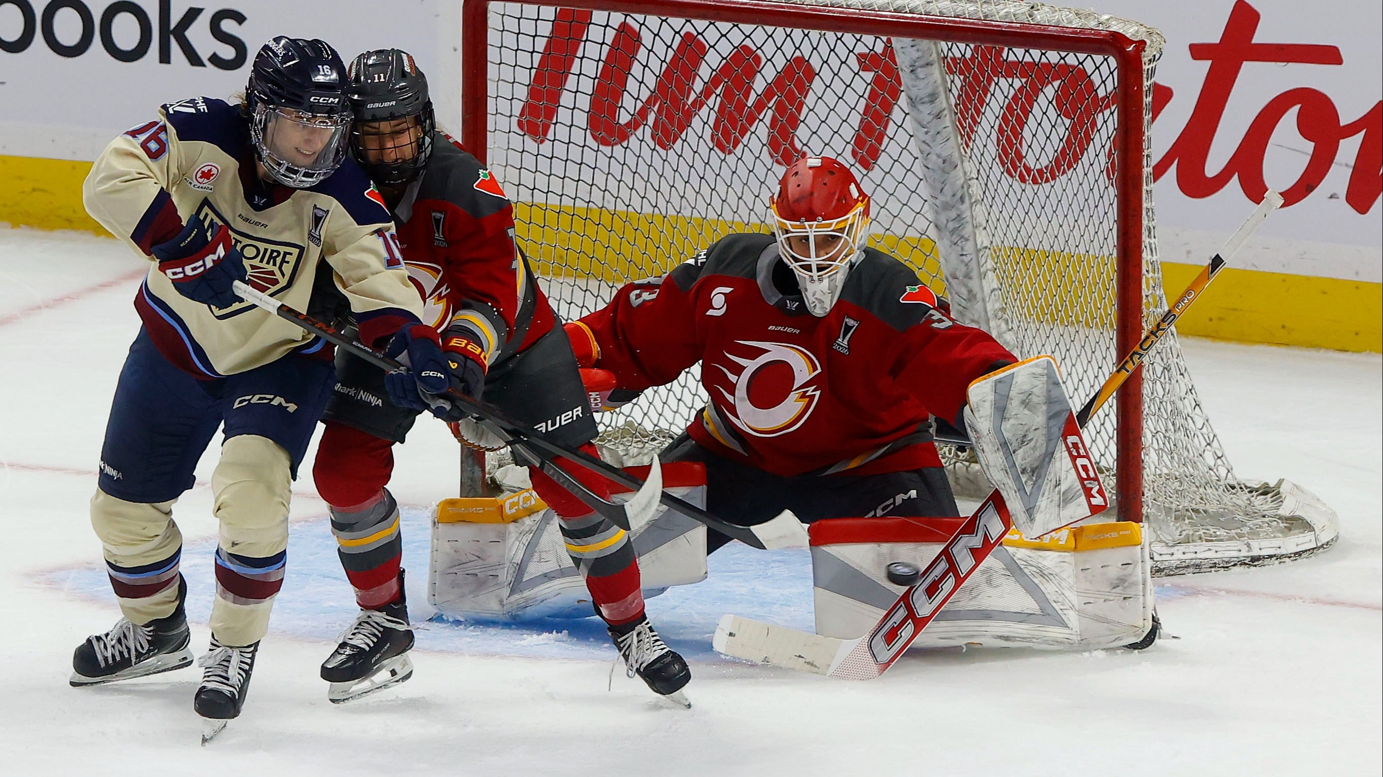Brooke Hobson (#11) pushes away a Montreal attacker to give her goaltender a better view at the incoming puck during Game 3 of the PWHL finals.