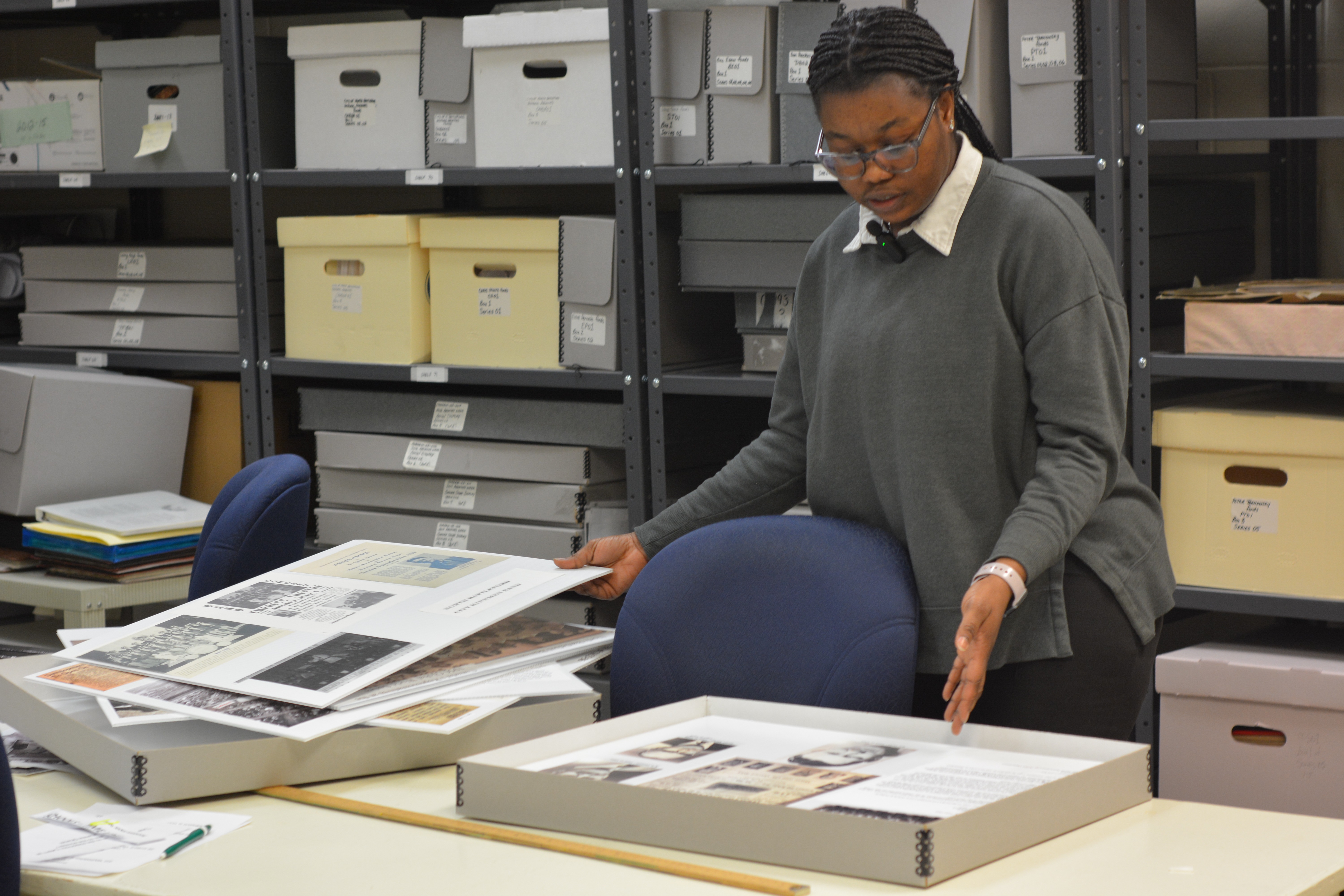Jessica Addo, the City of North Battleford’s senior gallery associate and part-time archivist, reviews displays from previous Archives Week exhibits inside her office at the Don Ross Centre.
