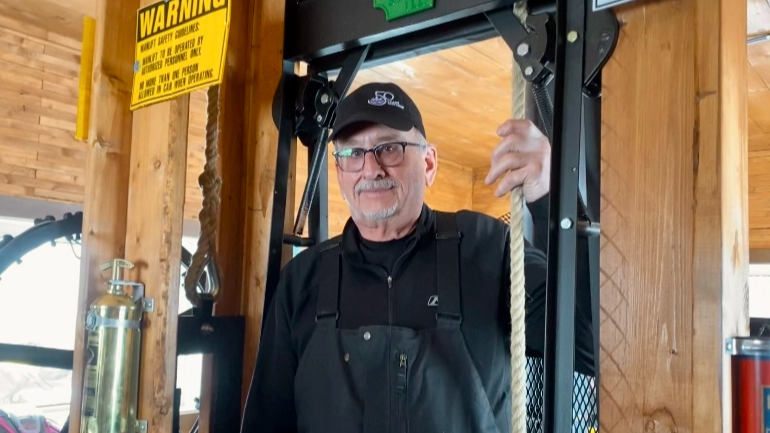 Dale Charabin trying out the man lift in the Hamlin shelter.