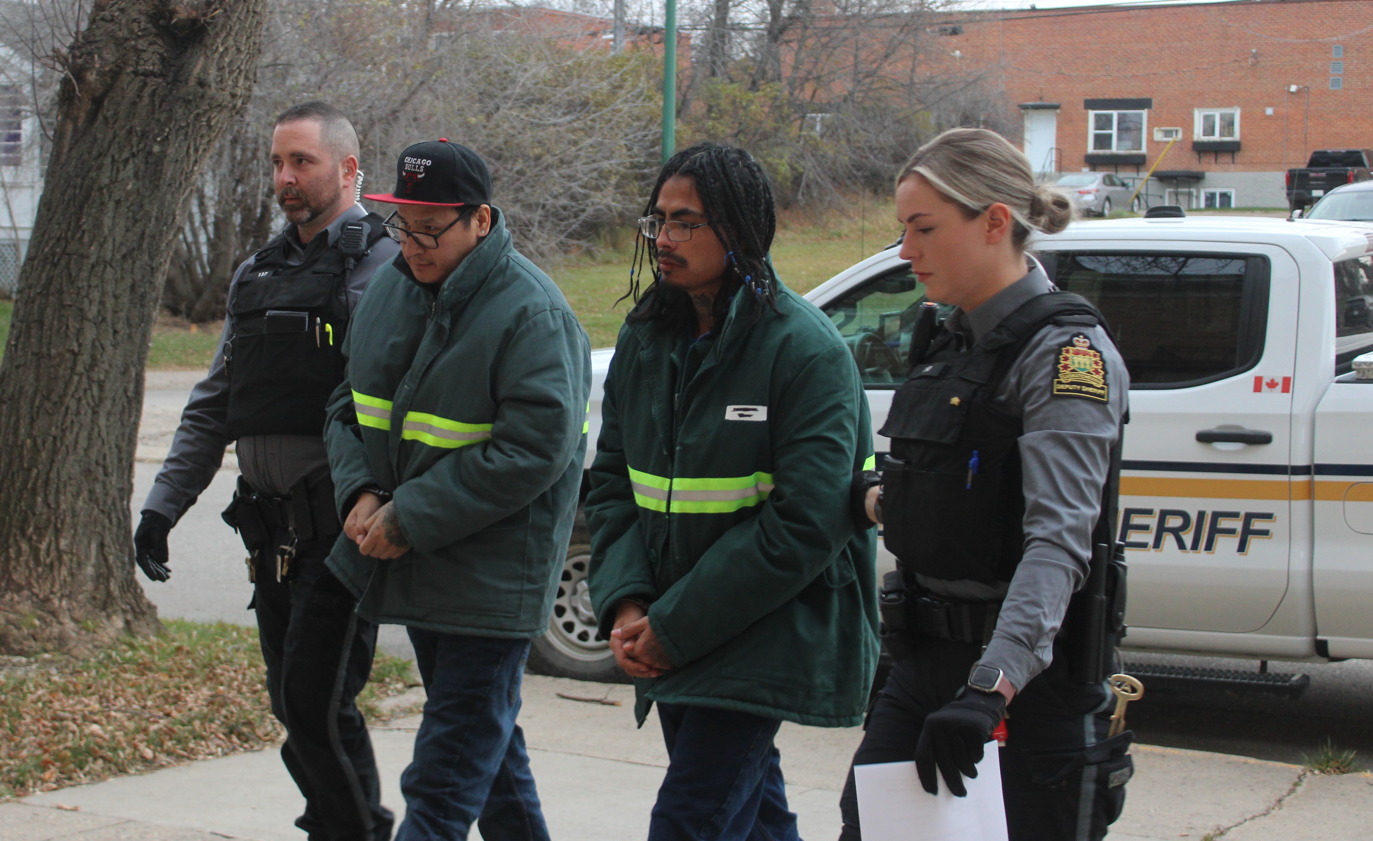 George Custer (left) and Rene Merasty are escorted to Court of King's Bench.