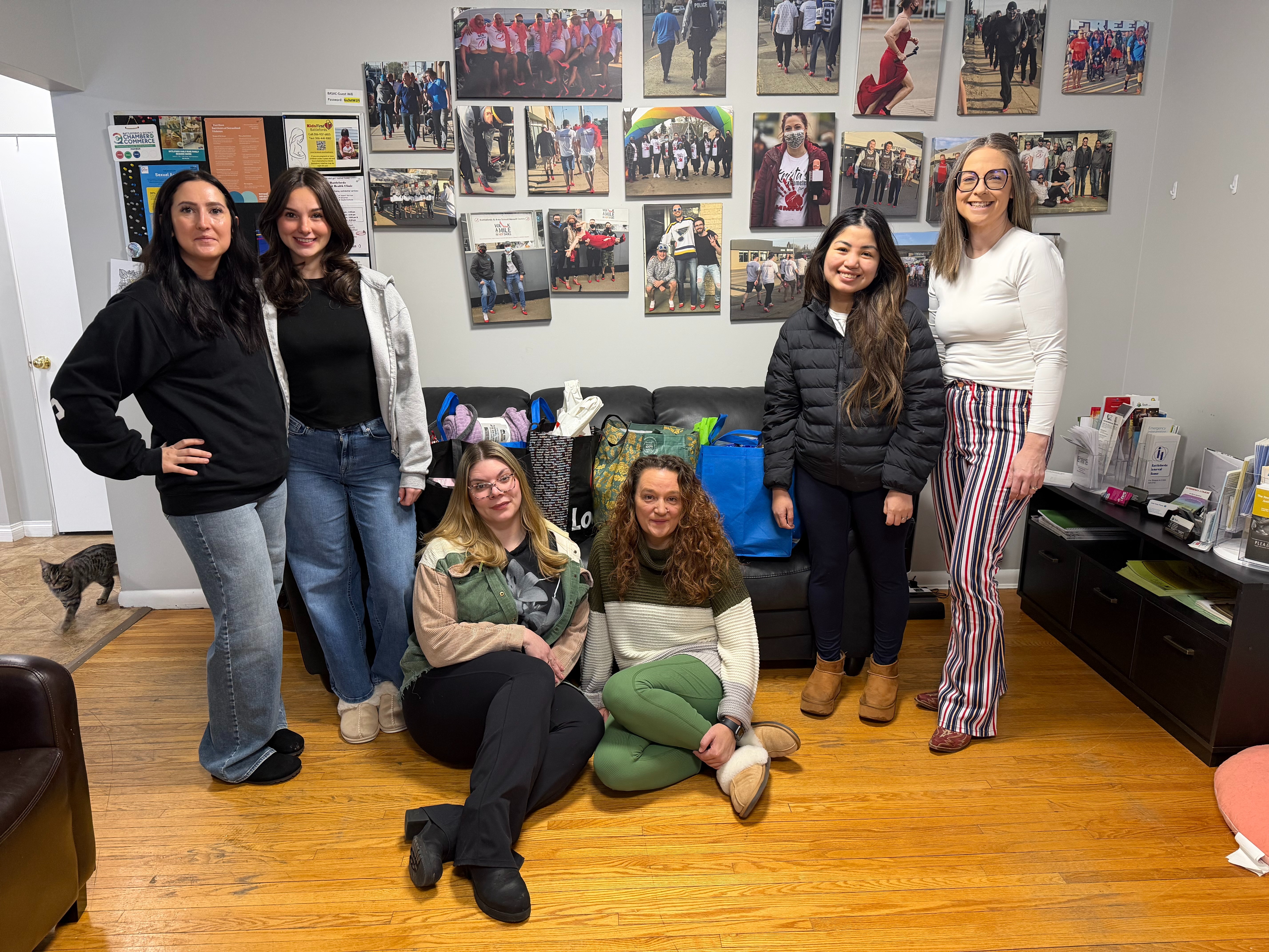 Anchor and Thread Community Services executive director Amber Stewart, far right, and Battlefords North Stars marketing manager Isabel Smith, next to Stewart, stand with centre staff beside donated essential supplies collected by North Stars families for women experiencing or fleeing violence.
