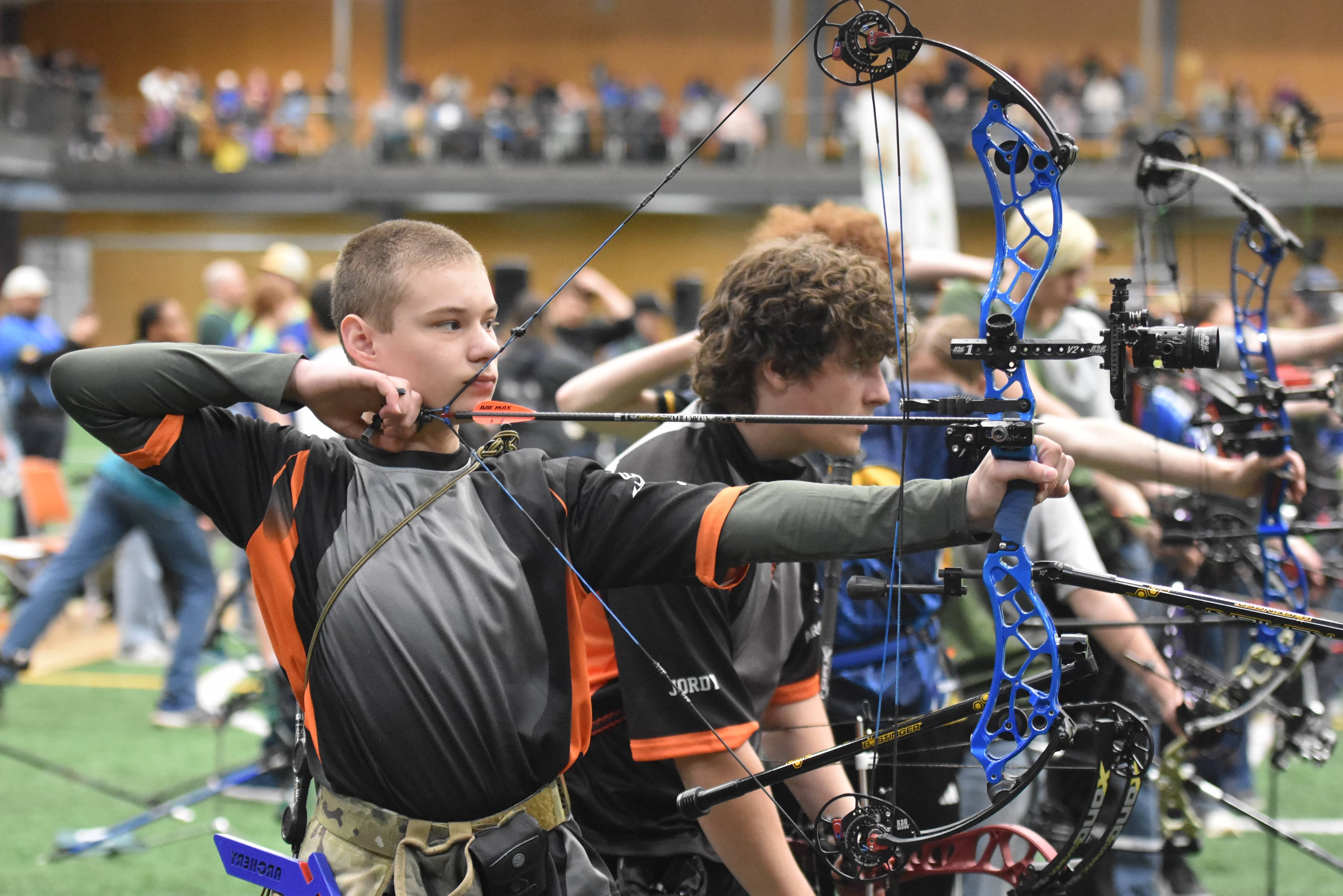 An archer with the Battle River Archers lines up his shot.