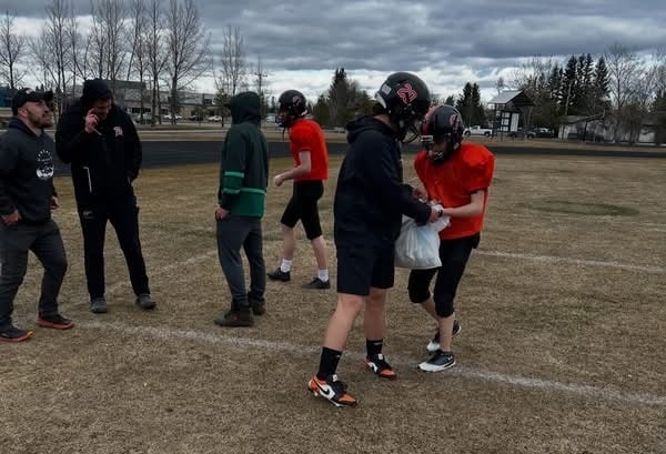 Carpenter High School Spartans players pick up garbage at Lions’ Park in Meadow Lake during spring camp.