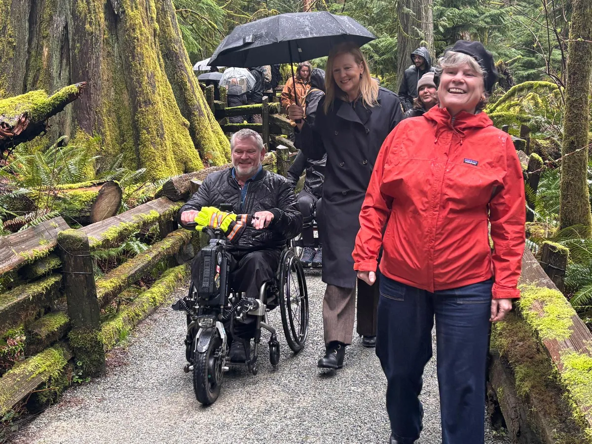MLA's Dana Lajeunesse, Brenda Baily (finance minister) and Josie Osborne (health minister) walking through Cathedral Grove.