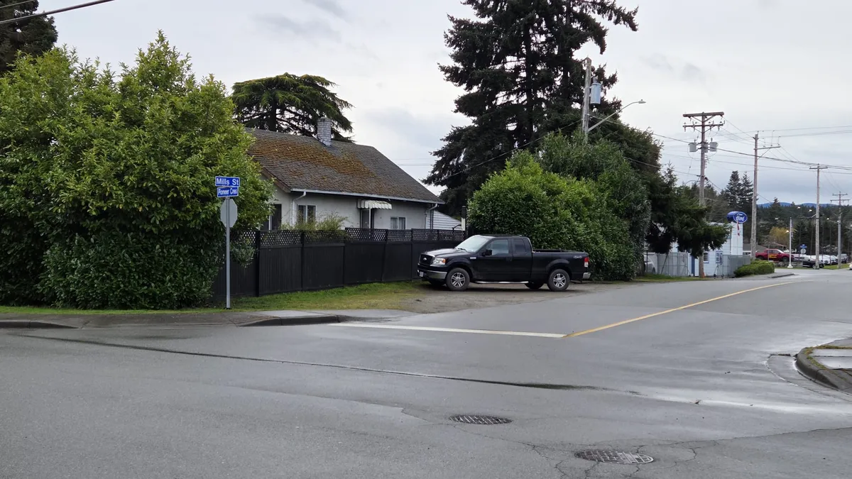 The lots feature a pair of single-family properties closest to Pioneer Cres., with commercial businesses facing the Island Hwy.