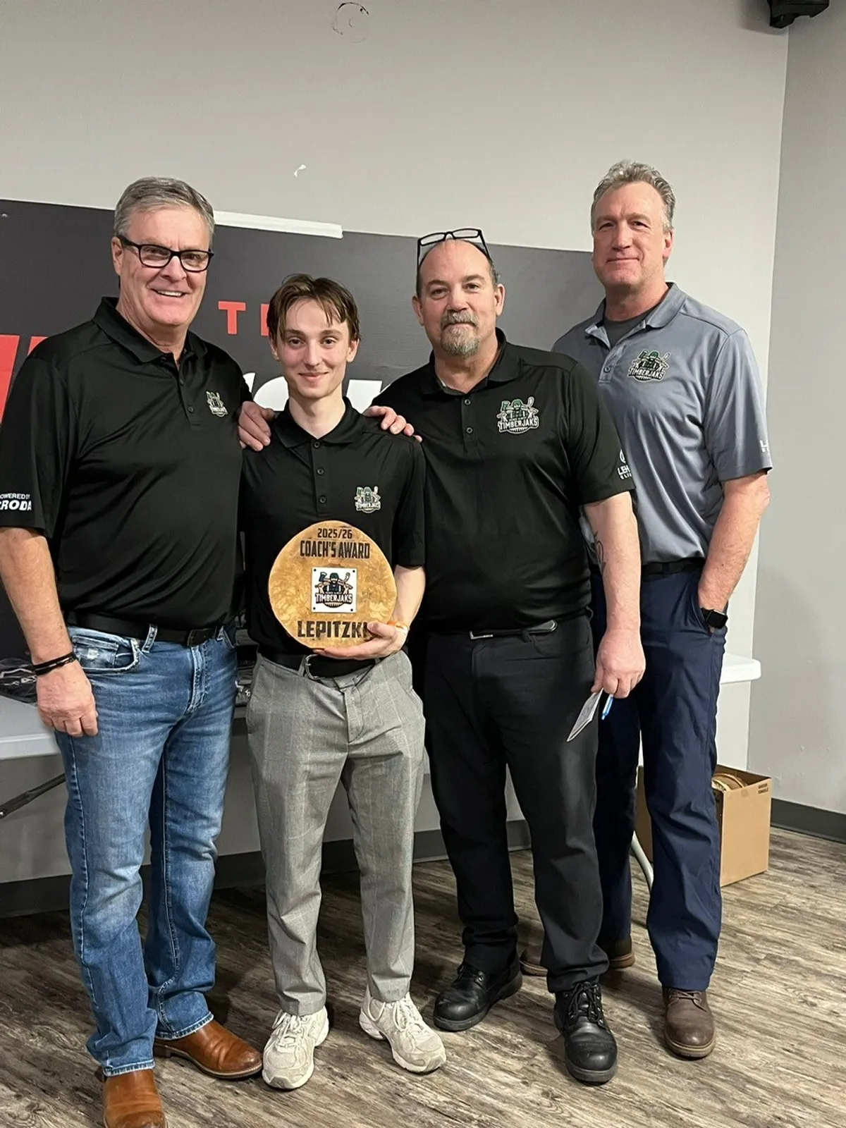 From left: Assistant Coach Tim Leonard, Coach's Award winner Ryan Leptizki, Head Coach Steph Corfmat, and Assistant Coach Kim Issel.