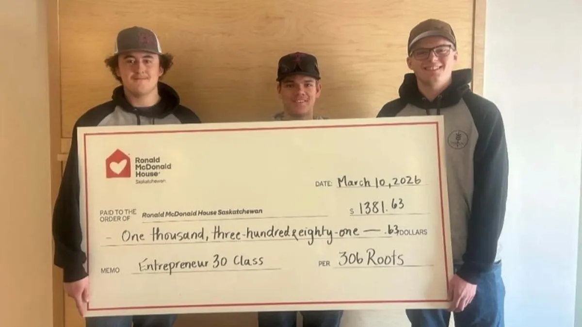 From left: Grayson Frolek, Nate Starycki, and James Woytiuk presenting a cheque to Ronald McDonald House.