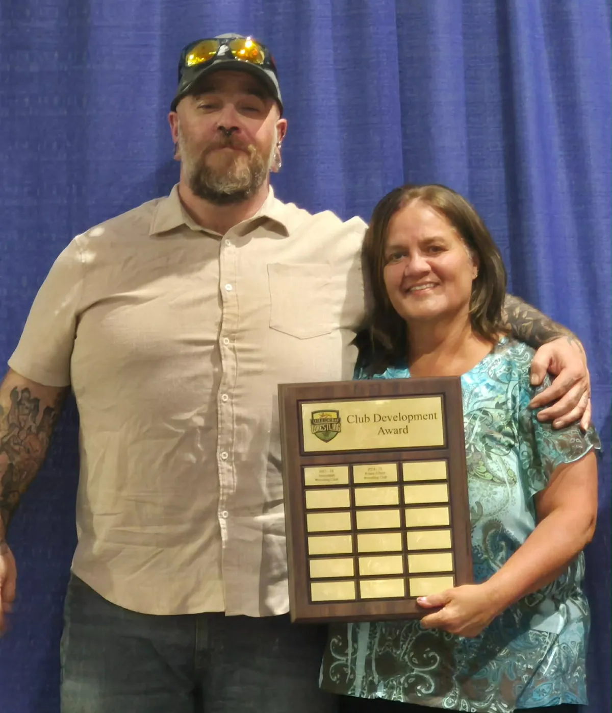 Cody Souter (left) and Roxanne Richards accept Sask Wrestling's Club Development Award that was given to the Prince Albert Wrestling Club during a banquet at the Provincial Championships in Prince Albert on March 28, 2026.