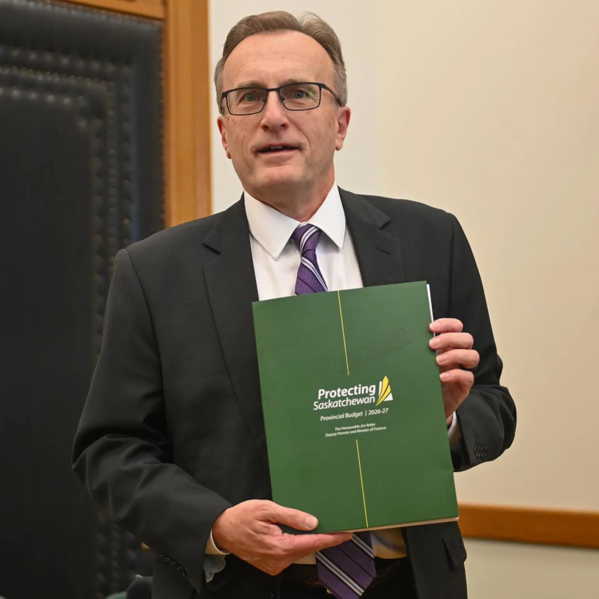 Finance Minister Jim Reiter with a copy of the 2026-27 Provincial Budget: Protecting Saskatchewan.