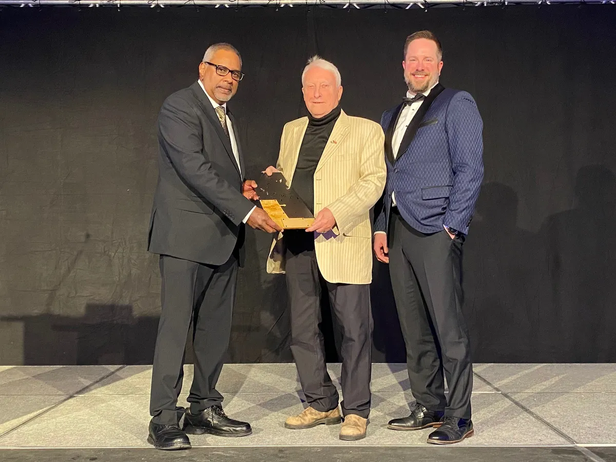Dr. Edmund Royeppen (left) was presented the Outstanding Achievement in Healthcare Award by Malcolm Jenkins (middle) and Cody Barnett, CEO of the Boreal Healthcare Foundation.