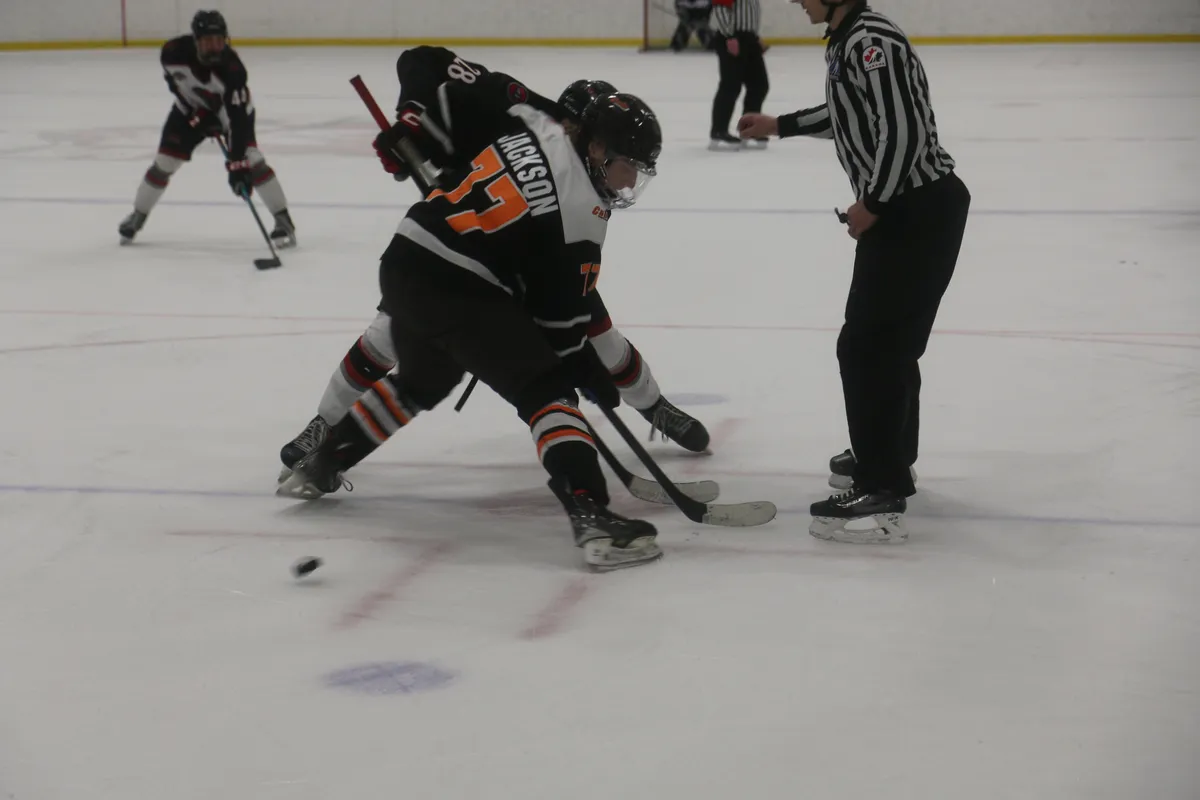 Cubs forward Josiah Jackson wins a draw during game two of the HJHL Finals on Sunday.