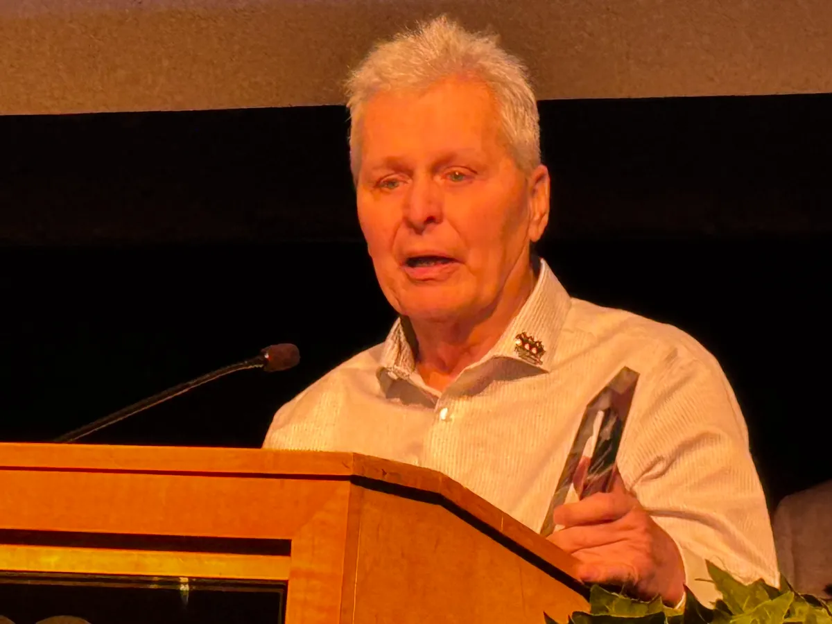 Terry Strubey, partner of the late Theresa Kolberg, accepts the Donor Legacy Award on her behalf.