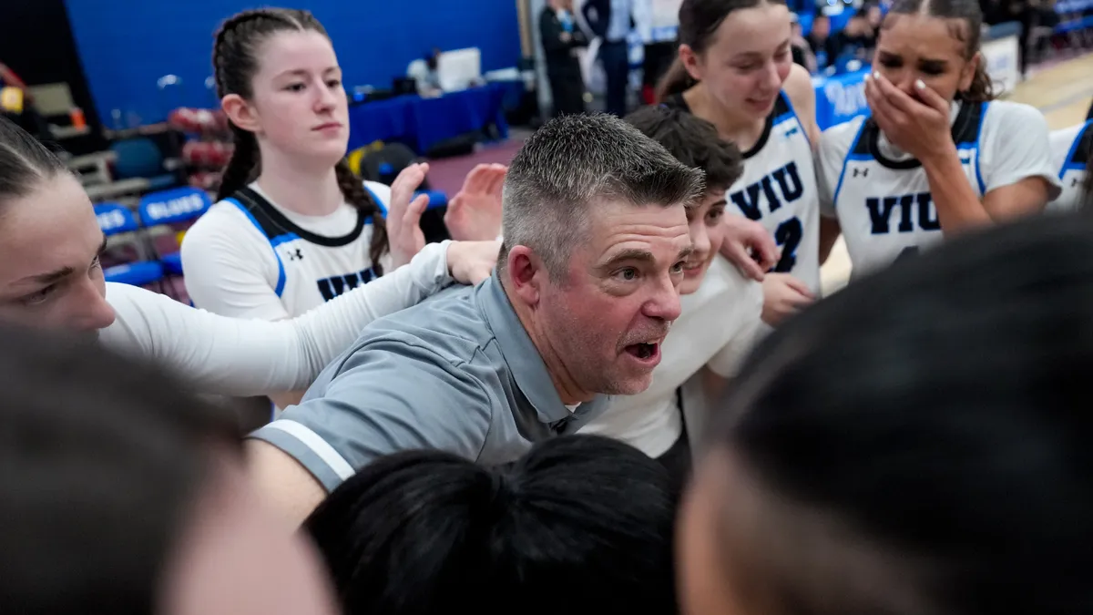 Tony Bryce addresses his team after winning the gold medal on Saturday night, his last game as head coach of the program.