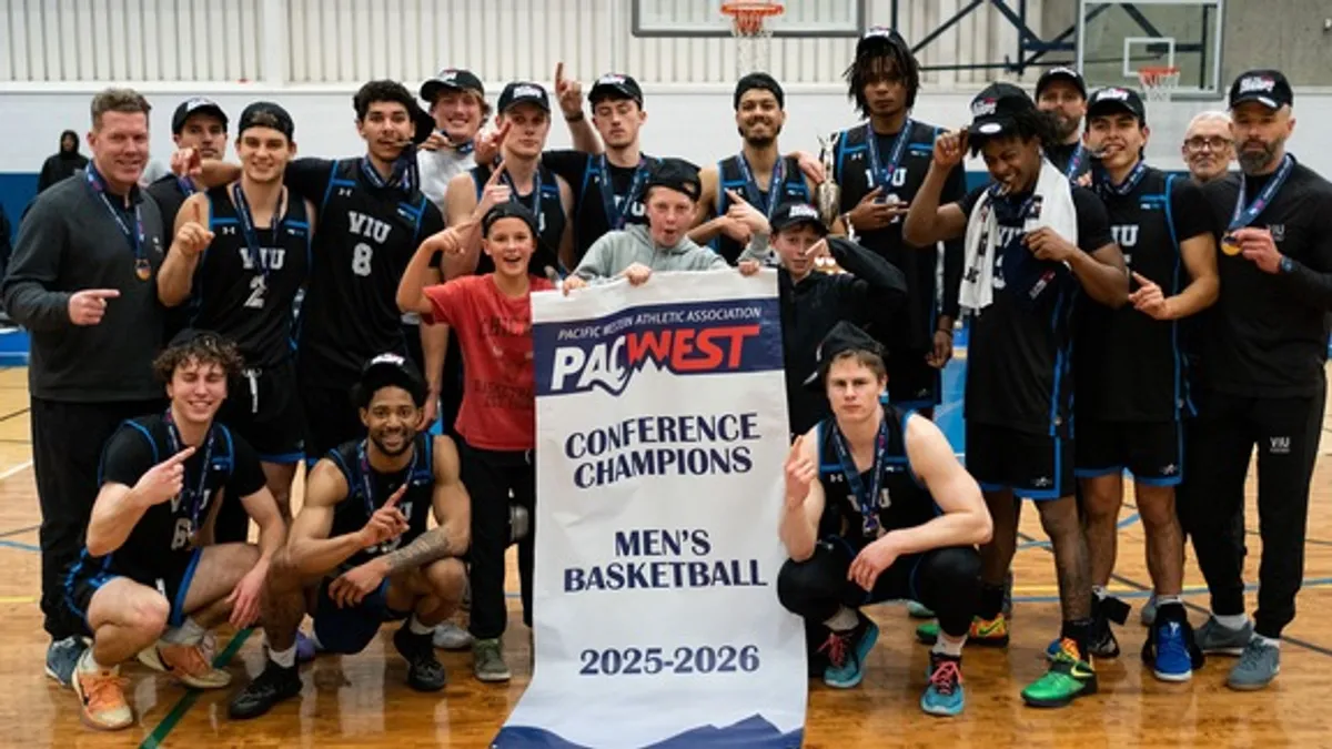 The men's team celebrate their buzzer beater victory Saturday night.