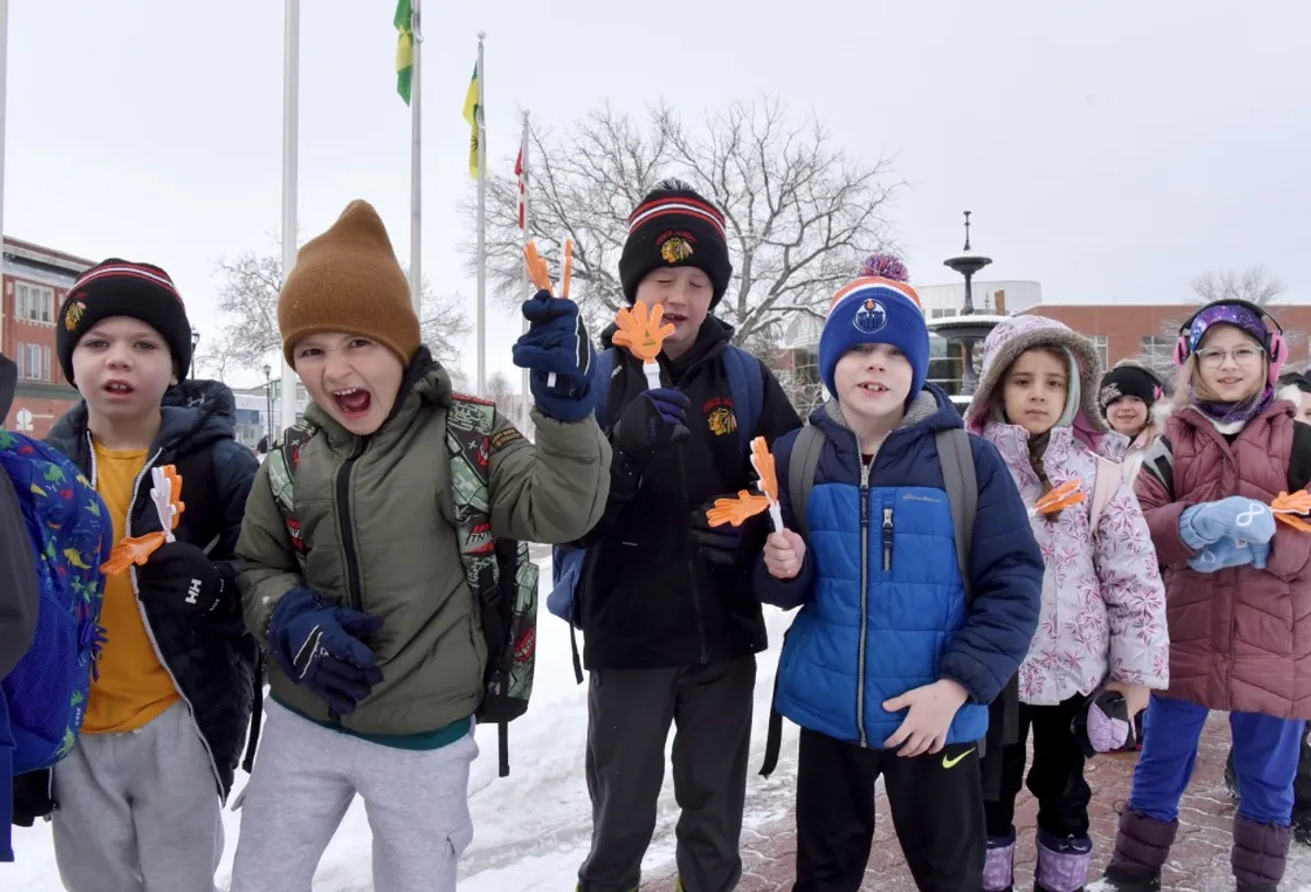 Ask eight- or nine-year-old children to pose for a camera and they will not disappoint. These students were glad to ham it up prior to their march.